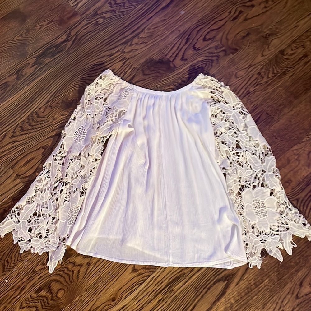 white shirt with lace flower sleeves